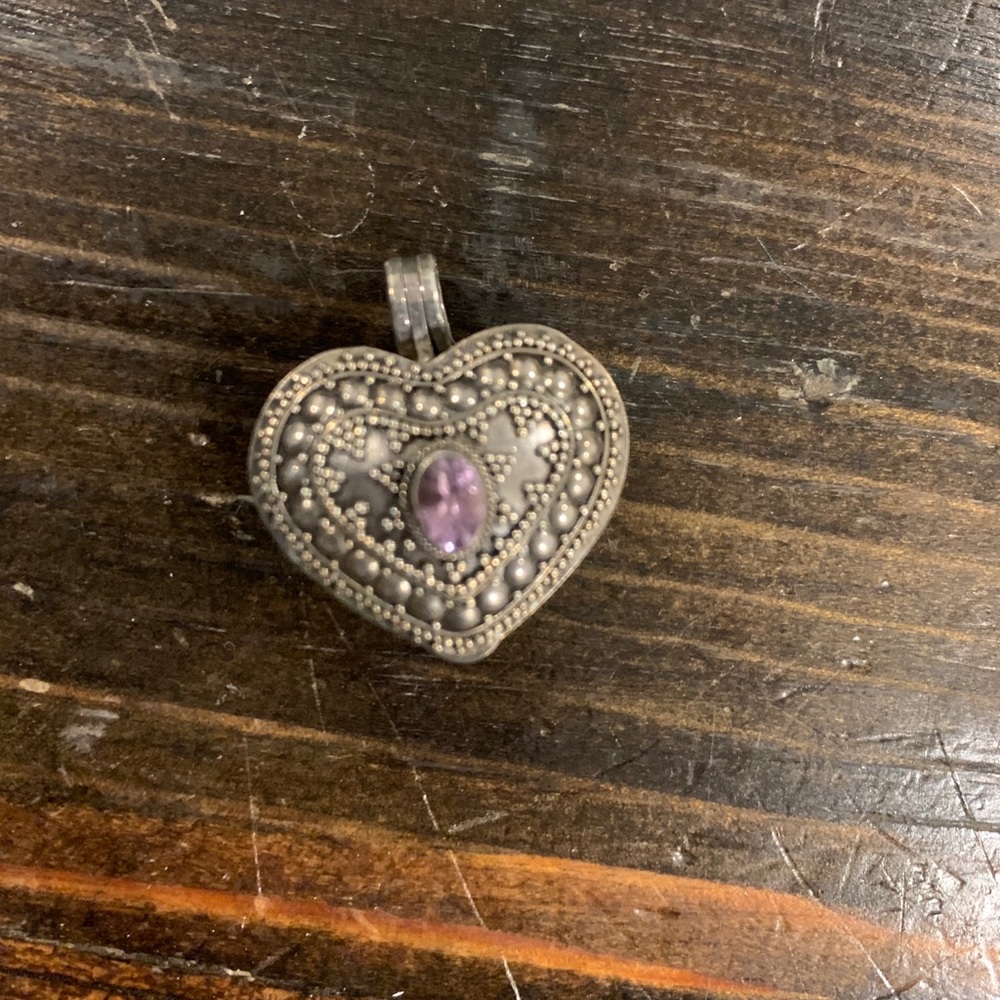 Silver heart shaped locket with purple stone